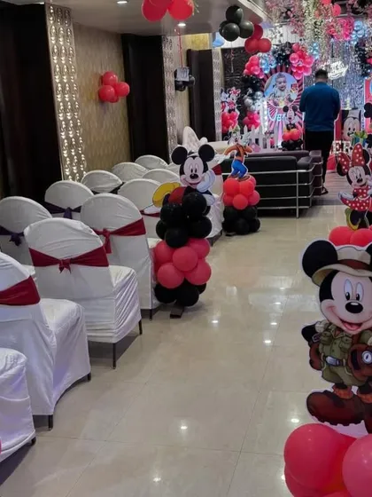 For this Mickey Mouse party, I decorated the entire hall, including character cutouts lining the aisle for the guests.