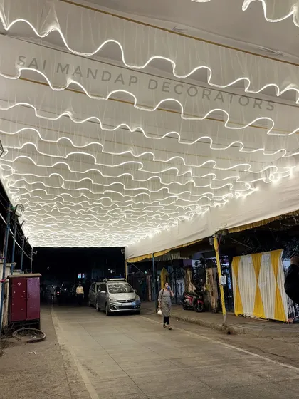 This is an entrance I decorated for a local Aagri-Koli event. The wavy LED light ceiling creates an inviting and festive pathway for guests arriving at the venue.