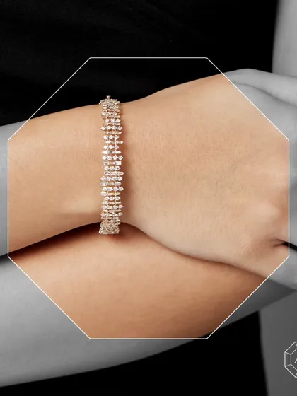 This diamond bracelet is a testament to timeless beauty and radiant charm. Crafted in 18kt gold with a stunning combination of round and baguette diamonds, it's a perfect symbol of refined taste.