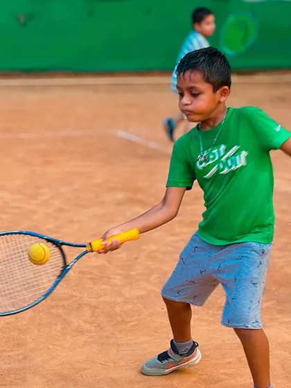 Perfect focus from a young player. This is a great example of a beginner connecting with the ball on a forehand shot, keeping his eye on the target. Badiya!
