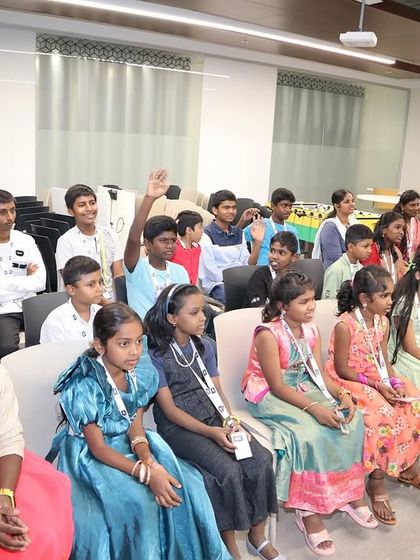 A group of children eagerly listening and participating in a workshop. Their curiosity and enthusiasm are the best part of teaching.