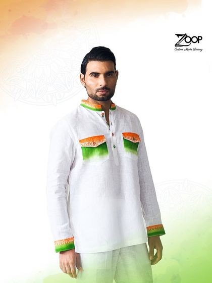 A full-length view of our patriotic-themed kurta. The clean white fabric with subtle tricolor accents on the collar, cuffs, and pockets makes for a sophisticated celebratory outfit.