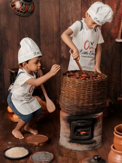 A sibling chef session. These two little cooks are hard at work, creating a fun and interactive scene that captures their bond.