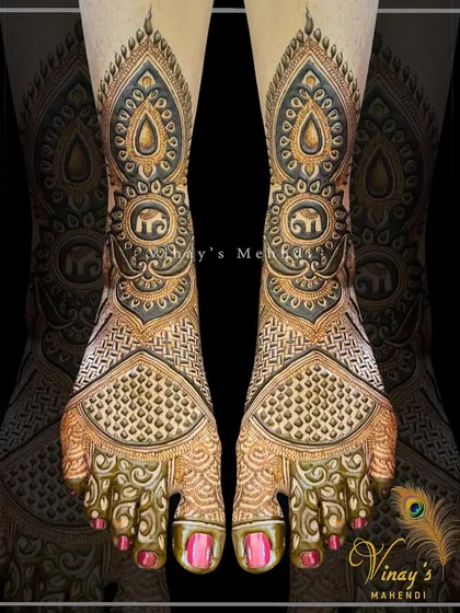 A detailed foot design with elephant motifs and intricate patterns covering the entire foot. The use of negative space creates a beautiful contrast.