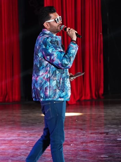 Walking the stage, script in hand. Constant movement and engagement are key elements of my dynamic hosting style.