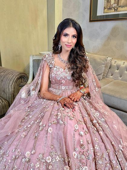 Seated and looking like royalty. The soft glam makeup, combined with her magnificent pink gown and diamond jewelry, creates an unforgettable engagement look.