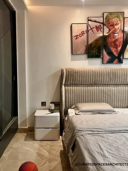 This beige bedroom was designed for a teenager who loves simplicity and anime. The custom "Zoro" artwork above the bed adds a personal touch, reflecting his interests in a stylish way.