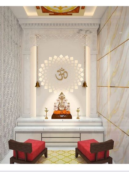 A pooja room design concept that combines white marble with intricate gold detailing. The back wall features a beautiful lotus-inspired jali pattern, creating a serene and divine atmosphere.