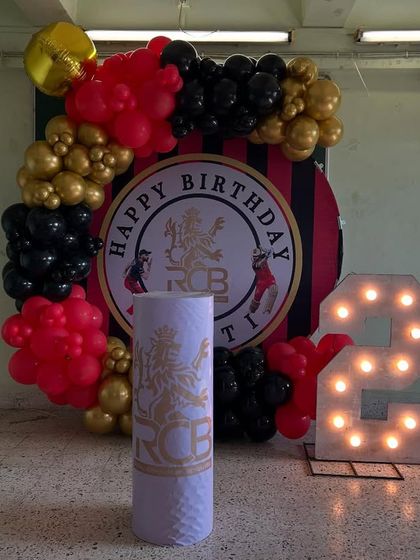 For a true cricket fan, this RCB-themed 25th birthday was a big hit. The setup featured the team's logo and colors in a bold balloon arrangement, complete with large light-up numbers.