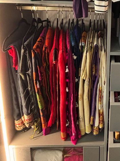 A collection of sarees hung neatly, showcasing their vibrant colors and patterns. This method is ideal for sarees that are worn more frequently.