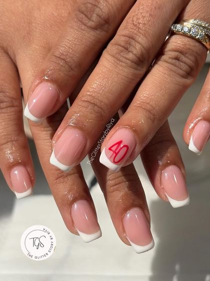 A classic French manicure with a personal touch. This clean and simple set features a custom hand-painted "40" on the ring finger to celebrate a special milestone.