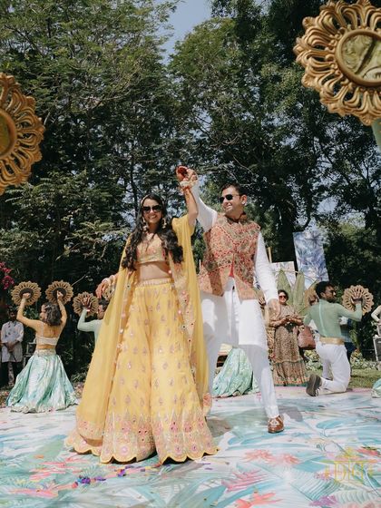 The Mehendi ceremony is all about joy and togetherness. Here, the bride and groom lead a dance, their happiness radiating and setting the tone for a fun-filled celebration.