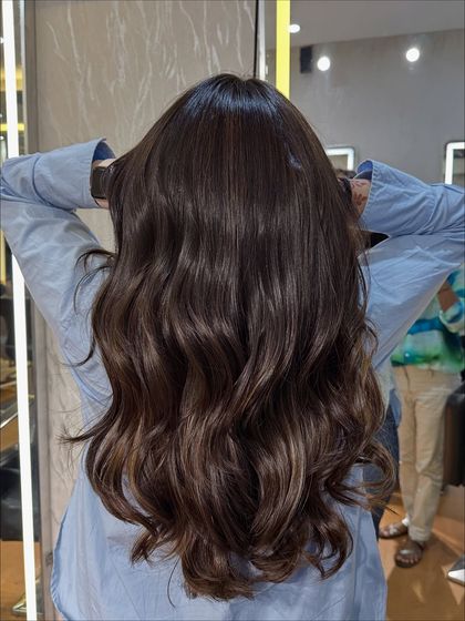 The client showing off her new Chocolate Mocha Brown hair. The color is vibrant and makes her hair look incredibly healthy.