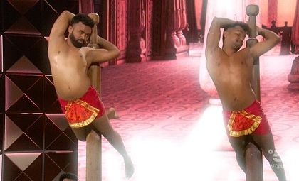 Two of our artists performing synchronized poses during the 'Lo Show Dei Record' performance. The aesthetics and symmetry of the movements are a key part of what makes Mallakhamb so captivating to watch.