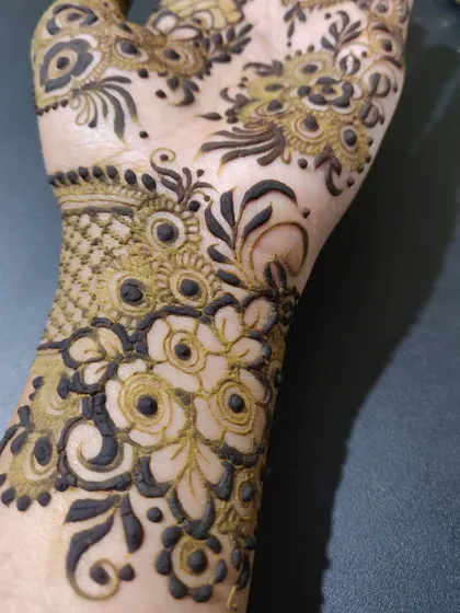 A duplicate image of the detailed floral work on the wrist.