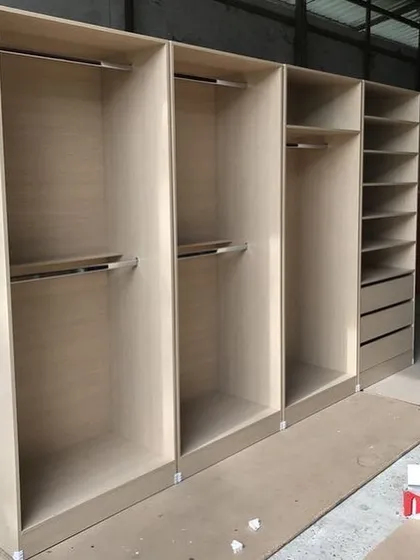 A behind-the-scenes look at a wardrobe carcass being built in our workshop. This shows the sturdy BWP wood structure, with sections for hanging rails, shelves, and drawers, highlighting the quality of our manufacturing process.