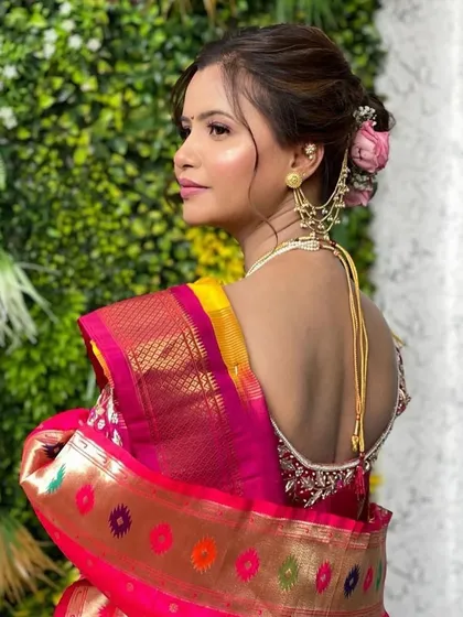 A back view of Siddhi's traditional Maharashtrian bridal hairstyle. The classic bun is adorned with beautiful accessories, completing her regal look.