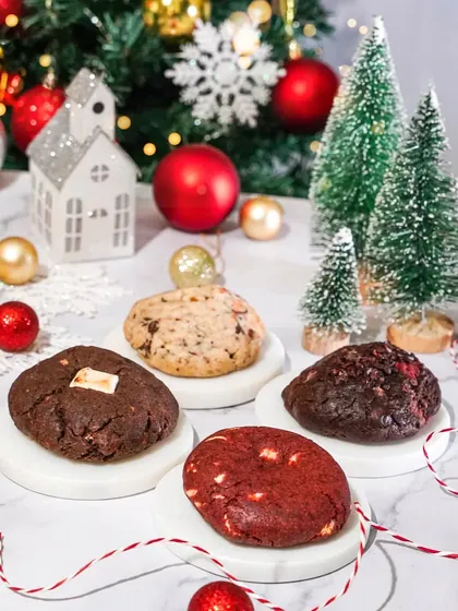 An assortment of gourmet Christmas cookies arranged in a festive winter wonderland scene. This shot is perfect for showcasing a holiday cookie collection.