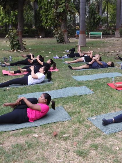 A moment of collective release. The cool grass and gentle breeze make this supine twist even more restorative and relaxing.