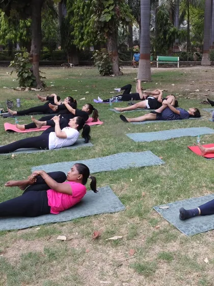A moment of collective release. The cool grass and gentle breeze make this supine twist even more restorative and relaxing.