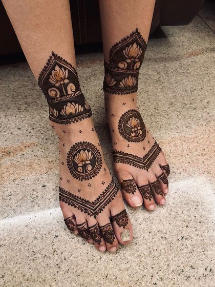 This design features bold lotus mandalas on the top of the foot and ankle, using negative space to create a striking and contemporary look.
