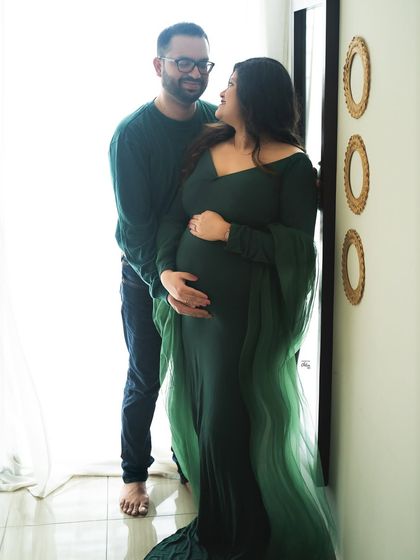 A loving glance. This bright, high-key photo shows the happy connection between the couple, framed by the soft light from the window.