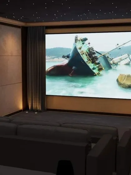 Experience movies on a grand scale with a wall-to-wall fixed screen and a professionally installed 4K projector. Here, we opted for a comfortable, expansive lounge sofa, perfect for casual family movie nights.
