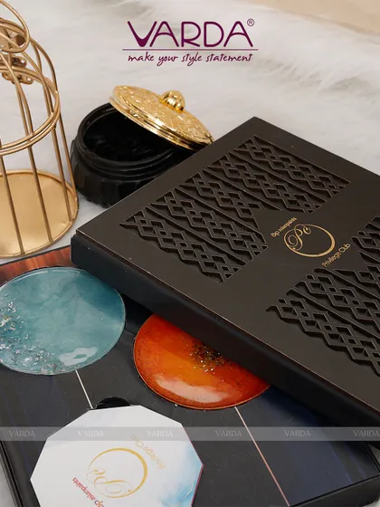 This modern corporate invitation features a laser-cut patterned box that opens to reveal custom-designed coasters. It demonstrates how an invitation can double as a sophisticated corporate gift, leaving a lasting impression on your guests long after the event.