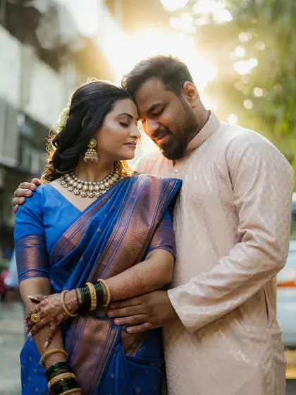 A beautifully lit outdoor portrait of an engaged couple, with the golden hour sun creating a magical glow.