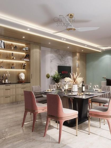 The perfect space for relaxing with friends or enjoying a cup of coffee. This open-plan living and dining area features soft pink chairs, a built-in bar cabinet, and a comfortable lounge area.