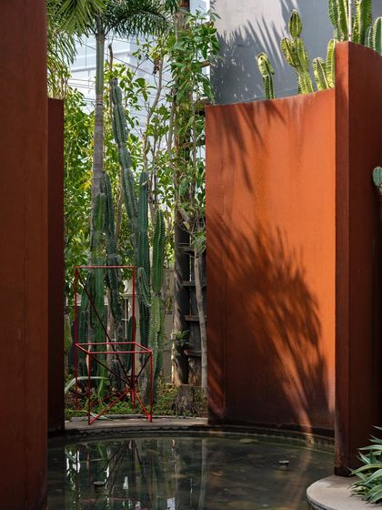 A bold water feature at the KEUS commercial hub, where sculptural Corten steel walls rise from the water. The design uses water to mask road noise and create a therapeutic, tranquil ambiance.