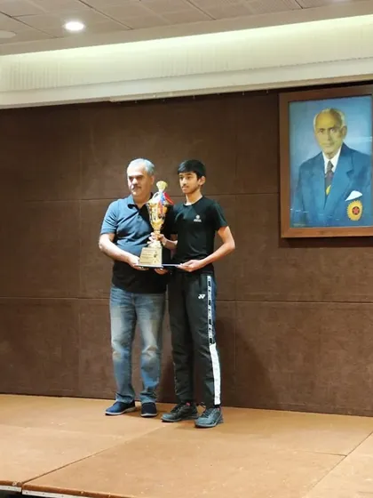Harshit being awarded the player of the tournament trophy at the CCI Greater Mumbai Yonex Sunrise District Badminton 2023.