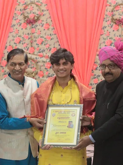 A student receiving his certificate after a heartfelt performance. We celebrate every step of our students' progress.