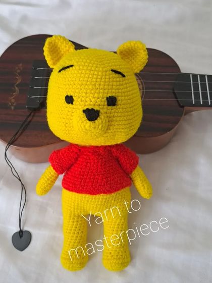 My Winnie the Pooh toy posing with a ukulele, ready for a song.