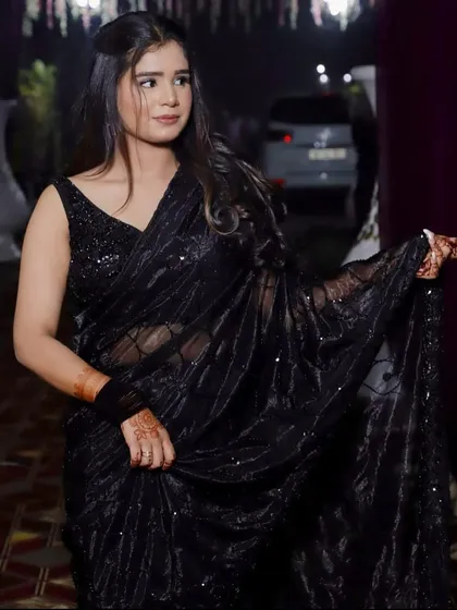For a modern and glamorous cocktail party or reception look, I offer this stunning black sequined saree. It’s a chic, elegant, and comfortable option that is sure to turn heads.