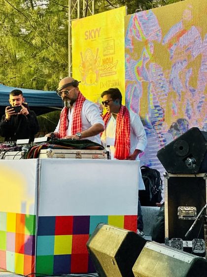 On the decks at a Holi party. The vibrant backdrop perfectly matches the energy of the festival.