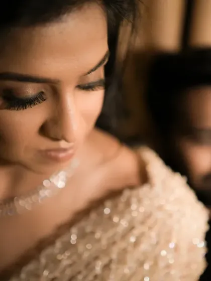 An artistic, moody portrait of the bride with the groom softly out of focus in the background. This creates a sense of depth and intimacy.