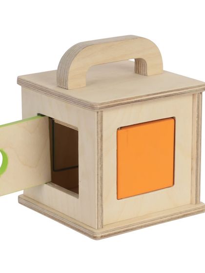A wooden toy box with colorful doors, shot to show one door ajar.