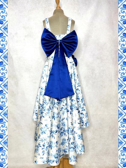 The back of our blue floral set is all about the drama of this oversized, deep blue satin bow. It's an unexpected detail that elevates the entire outfit.