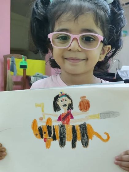 This artwork depicts the goddess Durga riding her tiger. The child's interpretation is powerful and unique, showing how cultural stories can inspire young artists to create their own powerful imagery.