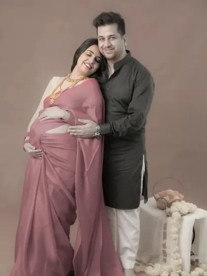 Elegance and tradition. This couple looks absolutely regal in their ethnic attire for this classic, beautifully lit studio maternity portrait.