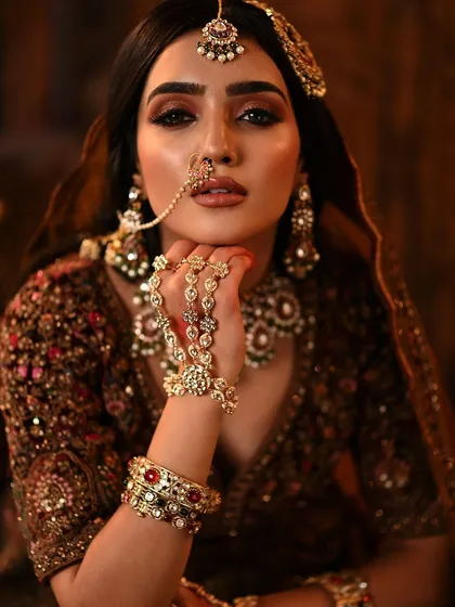 A beautiful portrait focusing on the hand jewelry and the intense, smoky eye makeup.