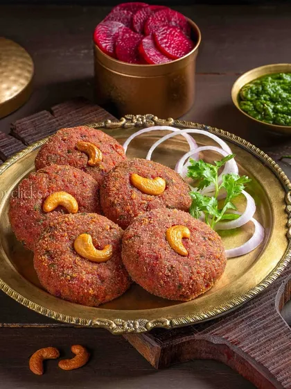 Beetroot Kebab, a colorful and healthy appetizer. The vibrant red of the kebab is complemented by fresh greens for The Mughal House.