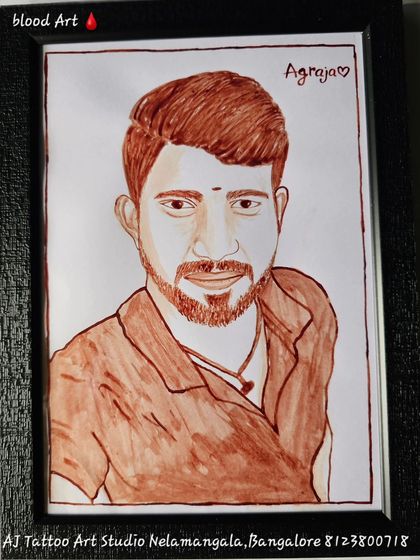 This framed blood portrait of a young man has the word "Agraja" (meaning elder brother) written on it. It's a respectful and loving tribute, made even more special by the medium.