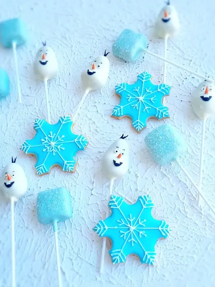 A close-up of the Frozen-themed treats, including Olaf cakepops and snowflake cookies.