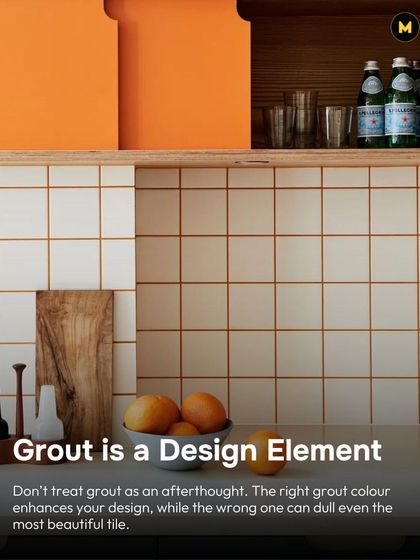 Grout is a design element, not an afterthought. The right grout color enhances your tile design, while the wrong one can dull even the most beautiful tile. Here, orange grout makes simple white tiles pop.