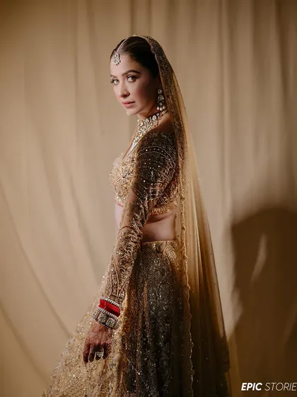 A graceful side profile of Malvika. The soft fabric background and the gentle lighting create a simple yet stunning portrait that emphasizes her elegance.