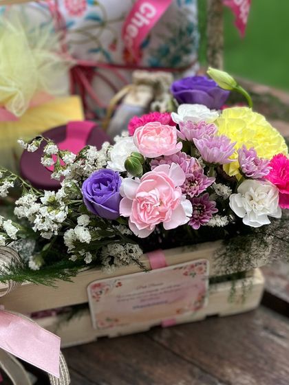 A detail of the personalized card and the fresh, colorful flowers that say "we're thinking of you."