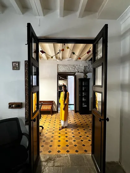A view through the main doors of the studio, where our team member Sumina stands in a ray of sunlight. The space feels open and welcoming, with its original floors and high ceilings, a true reflection of the collaborative spirit we foster here.