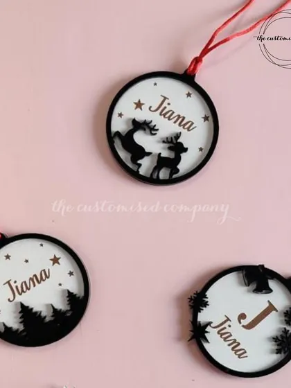 For a more elegant and modern look, we offer these beautiful layered Christmas ornaments. Each one is personalized with a name, creating a unique and cherished decoration.
